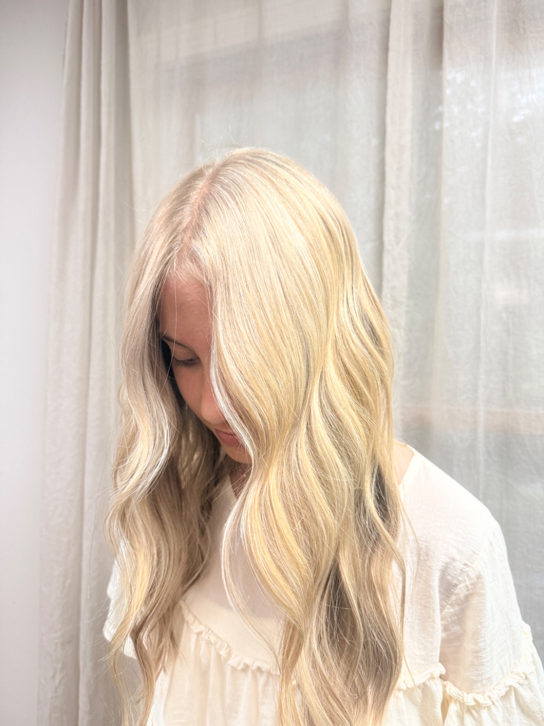 Soft pale blonde, lit by a window.