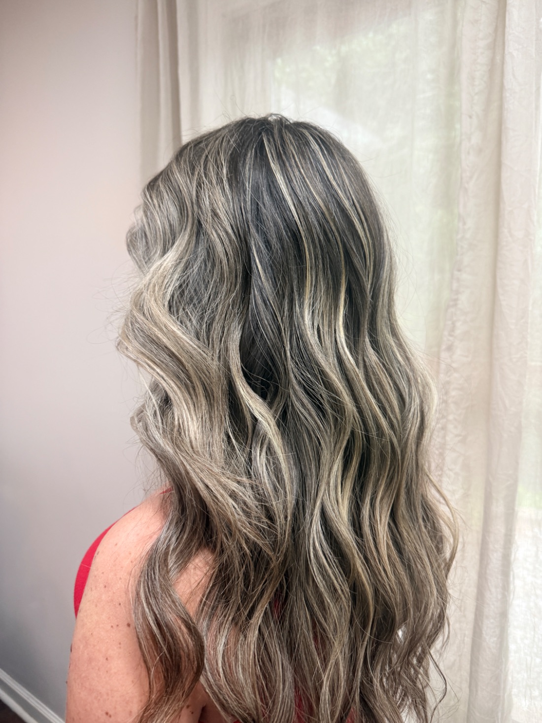 Dark hair with fine ribbons of silver through it.